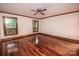 A bedroom with hardwood floors, natural light from multiple windows, neutral walls, and ceiling fan at 3700 Nw Gainesway Nw Ct, Concord, NC 28027
