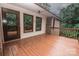 Exterior view of a wooden deck with access to the home, featuring a brick exterior and wooded views at 3700 Nw Gainesway Nw Ct, Concord, NC 28027