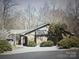 Exterior view of a single-story brick house surrounded by mature trees and bushes at 3700 Nw Gainesway Nw Ct, Concord, NC 28027