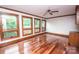 Bright living room with hardwood floors, multiple windows, and a ceiling fan at 3700 Nw Gainesway Nw Ct, Concord, NC 28027