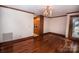 Dining room featuring hardwood floors, a chandelier, and view of the kitchen at 3700 Nw Gainesway Nw Ct, Concord, NC 28027