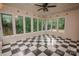 Bright sunroom with checkered floors and lots of windows providing natural light and showcasing the surrounding landscape at 3700 Nw Gainesway Nw Ct, Concord, NC 28027