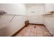 Spacious walk-in closet featuring metal shelving, tile floors, and wood trim at 3700 Nw Gainesway Nw Ct, Concord, NC 28027