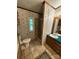 Bathroom featuring a toilet, shower and vanity with floral wallpaper at 400 Archibald Rd, Concord, NC 28025