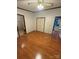 Bright, airy bedroom featuring hardwood floors with entrances to bathroom and kitchen at 400 Archibald Rd, Concord, NC 28025