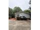 Well-maintained single-story home with wood steps and landscaped front yard creates a welcoming curb appeal at 400 Archibald Rd, Concord, NC 28025