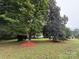 Large trees and red mulch add to the curb appeal of this home, providing a shady and inviting exterior at 400 Archibald Rd, Concord, NC 28025