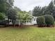 Charming single-story home with well-maintained lawn and mature landscaping creates inviting curb appeal at 400 Archibald Rd, Concord, NC 28025
