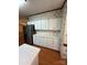 Bright kitchen featuring white cabinets, stainless steel appliances and wood flooring at 400 Archibald Rd, Concord, NC 28025