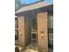 Brick building featuring an arched entry, glass doors, and stairway entrance in daylight at 415 Orchard Trace Ln # 8, Charlotte, NC 28213