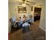 Dining room with decorative fruit themed artwork, a ceiling fan, and an adjacent kitchen at 415 Orchard Trace Ln # 8, Charlotte, NC 28213