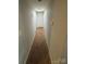 Hallway with carpet, a white door at the end, and painted white walls at 415 Orchard Trace Ln # 8, Charlotte, NC 28213