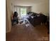 Living room with carpeting and decorated with plants, pillows, and an outside view at 415 Orchard Trace Ln # 8, Charlotte, NC 28213