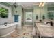 This luxurious bathroom features a soaking tub, double vanities, and a glass shower at 417 N Dotger Ave, Charlotte, NC 28204