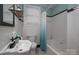 Classic bathroom with tiled walls and a blue and white shower curtain at 417 N Dotger Ave, Charlotte, NC 28204