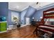 Fun ' bedroom with dark hardwood floors and bright blue walls at 417 N Dotger Ave, Charlotte, NC 28204