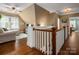 Open bonus room with hardwood floors, a ceiling fan, and bright natural light at 417 N Dotger Ave, Charlotte, NC 28204