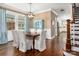 Bright dining room boasts hardwood floors, a modern light fixture, and a charming blue china cabinet at 417 N Dotger Ave, Charlotte, NC 28204