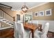 Inviting dining room boasts hardwood floors, a statement light fixture and access to the staircase at 417 N Dotger Ave, Charlotte, NC 28204