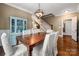 Charming dining room features hardwood floors, a statement light fixture and access to staircase at 417 N Dotger Ave, Charlotte, NC 28204
