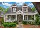 Charming two-story home features a covered porch, lush landscaping, and inviting curb appeal at 417 N Dotger Ave, Charlotte, NC 28204