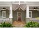 Inviting front porch features classic columns, ceiling fans, and a warm, welcoming ambiance at 417 N Dotger Ave, Charlotte, NC 28204