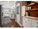 Hallway leading into the kitchen features hardwood floors, custom shelves and granite countertops at 417 N Dotger Ave, Charlotte, NC 28204
