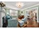 Elegant living room featuring hardwood floors, fireplace, and an open layout to dining area at 417 N Dotger Ave, Charlotte, NC 28204