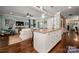 Open concept kitchen island overlooks a living room with hardwood floors and blue walls at 417 N Dotger Ave, Charlotte, NC 28204