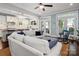 Cozy living room with a large white sofa, ottoman, and rocking chair at 417 N Dotger Ave, Charlotte, NC 28204