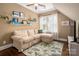 Cozy living room features a comfortable sofa, bright windows, and unique wall decorations at 417 N Dotger Ave, Charlotte, NC 28204
