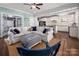 Bright and inviting living room with white sofa and adjacent eat-in kitchen at 417 N Dotger Ave, Charlotte, NC 28204