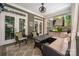 Covered outdoor patio with elegant furniture and a view of the landscaped backyard at 417 N Dotger Ave, Charlotte, NC 28204