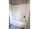 Clean and functional bathroom with white tub, showerhead, and gray tile flooring at 417 Trillium Sw Ct, Conover, NC 28613