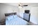 Bedroom features a grey bookcase headboard, ceiling fan and two closets at 417 Trillium Sw Ct, Conover, NC 28613