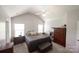 This bedroom has neutral carpet, an upholstered bench and two windows at 417 Trillium Sw Ct, Conover, NC 28613