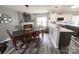 Open concept dining area with modern lighting, fireplace, and adjacent kitchen at 417 Trillium Sw Ct, Conover, NC 28613