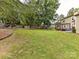 Large backyard with grass, a fire pit, pergola and hot tub at 4711 Truscott Rd, Charlotte, NC 28226