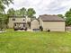 The backyard features a grass lawn, a fire pit, a pergola, and a hot tub at 4711 Truscott Rd, Charlotte, NC 28226