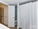 Clean bathroom featuring shower with curtain and an open door to the rest of the house at 4711 Truscott Rd, Charlotte, NC 28226