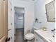 Bright bathroom featuring a modern vanity, toilet, and glass shelf adding style and functionality at 4711 Truscott Rd, Charlotte, NC 28226