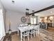 Open concept dining room, featuring a farmhouse table adjacent to the modern kitchen at 4711 Truscott Rd, Charlotte, NC 28226