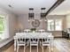 Open concept dining room with farmhouse table and decorative lighting at 4711 Truscott Rd, Charlotte, NC 28226