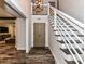 Inviting foyer with decorative wood floors, staircase, and an open view into the living room at 4711 Truscott Rd, Charlotte, NC 28226