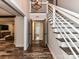 Bright foyer with decorative wood floors, staircase, and closet doors at 4711 Truscott Rd, Charlotte, NC 28226