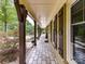 Long covered front porch with stone flooring, wood columns, and charming decorative accents at 4711 Truscott Rd, Charlotte, NC 28226