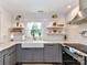 Modern kitchen with white subway tile backsplash, open shelving, and updated appliances at 4711 Truscott Rd, Charlotte, NC 28226