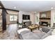 Bright living room features wood floors, a painted brick fireplace, and a comfortable gray sectional sofa at 4711 Truscott Rd, Charlotte, NC 28226