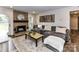Relaxing living room with fireplace, soft rug, and sectional couch at 4711 Truscott Rd, Charlotte, NC 28226