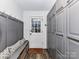 Functional mudroom with built-in bench seating, storage baskets, and gray cabinets for added convenience at 4711 Truscott Rd, Charlotte, NC 28226